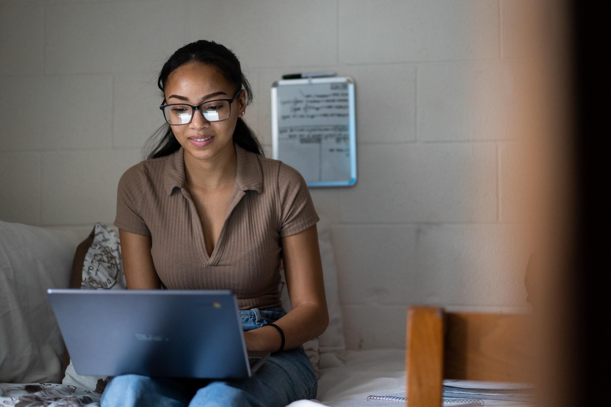 female student sitting working on a computer